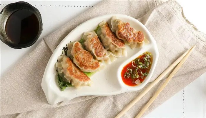 Pan-fried gyoza dumplings with spicy dipping sauce at Ikoi Sushi，a Sushi Restaurant in San Rafael