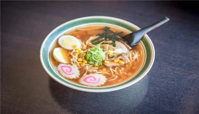 Savory shoyu ramen topped with chashu, egg and corn at Ikoi Sushi，a Sushi Restaurant in San Rafael