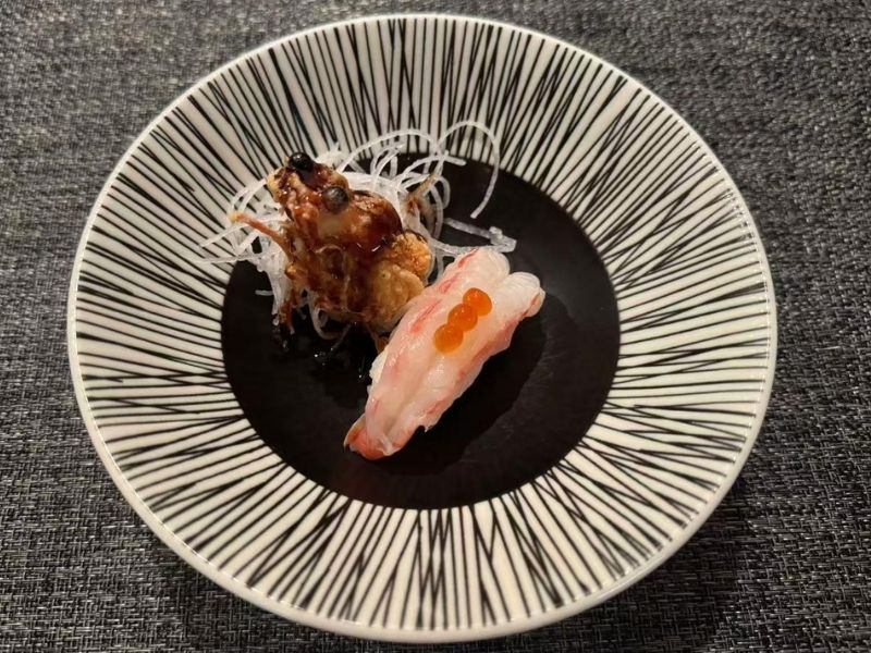 Ikyu-Sushi-II-Japanese-Restaurant-Botan-Ebi-New-York Botan ebi sushi with garnishes on a plate at Ikyu Sushi II, a Japanese Restaurant in New York.
