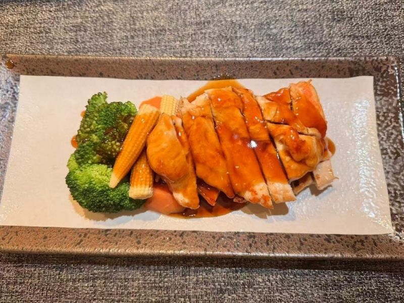 Sliced chicken teriyaki with veggies at Ikyu Sushi II, a Japanese Restaurant in New York.