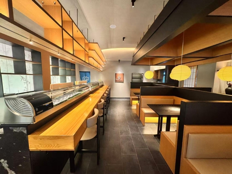 Ikyu-Sushi-II-Japanese-Restaurant-Combined-Area-New-York Combined sushi bar and booth area in a Japanese restaurant, a wooden sushi counter, a Japanese Restaurant in New York.