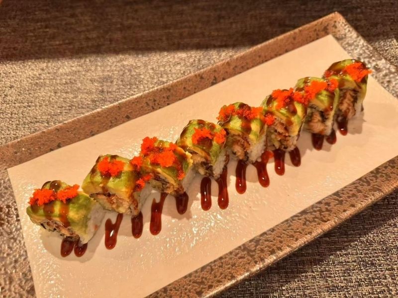 Ikyu-Sushi-II-Japanese-Restaurant-Dragon-Roll-New-York Dragon roll sushi with colorful toppings at Ikyu Sushi II, a Japanese Restaurant in New York.