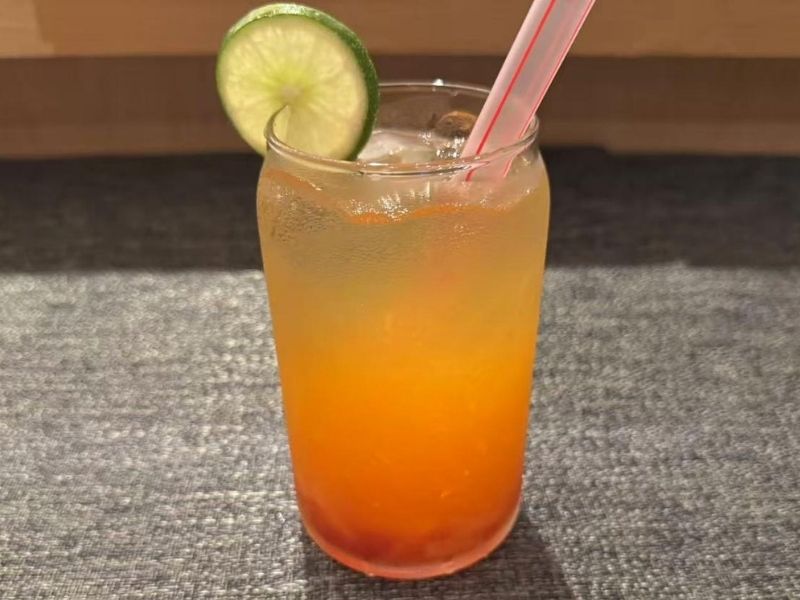 Grapefruit peach green tea with jelly and a lime slice at Ikyu Sushi II, a Japanese Restaurant in New York.