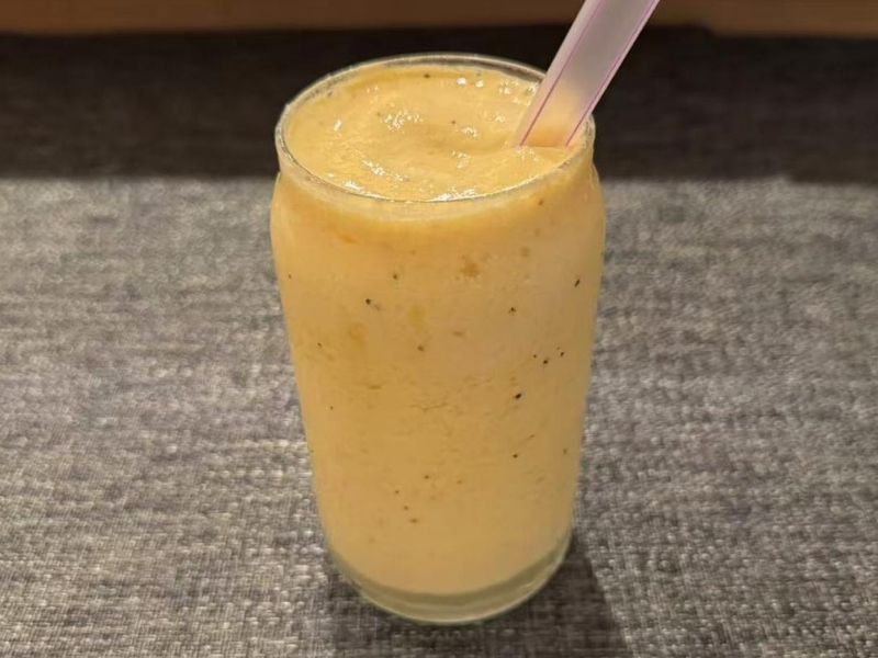 Ikyu-Sushi-II-Japanese-Restaurant-Mango-Smoothie-New-York Creamy mango smoothie in a glass at Ikyu Sushi II, a Japanese Restaurant in New York.
