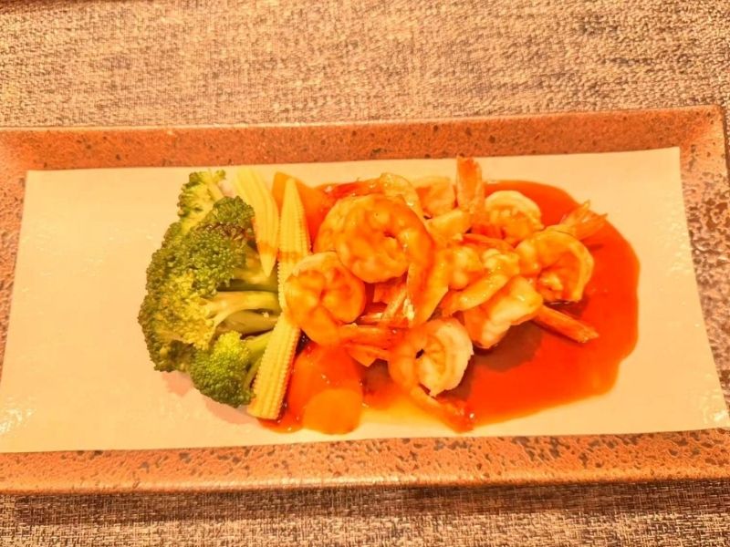 Plate of shrimp teriyaki with veggies at Ikyu Sushi II, a Japanese Restaurant in New York.