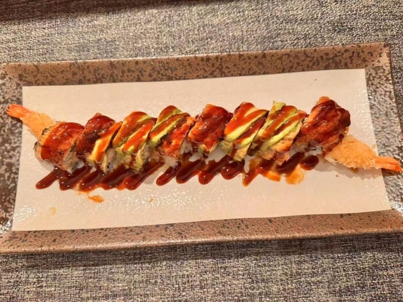 Titans roll sushi with drizzled sauce at Ikyu Sushi II, a Japanese Restaurant in New York.
