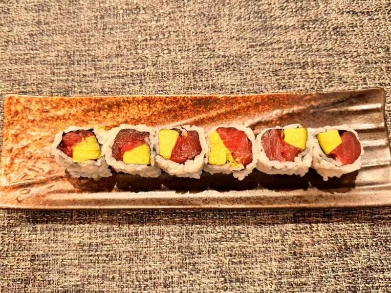 Tuna avocado roll sushi on a plate at Ikyu Sushi II, a Japanese Restaurant in New York.