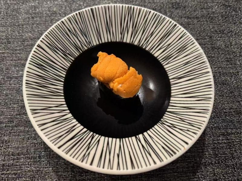 Ikyu-Sushi-II-Japanese-Restaurant-Uni-New-York Piece of uni sushi on a plate at Ikyu Sushi II, a Japanese Restaurant in New York.
