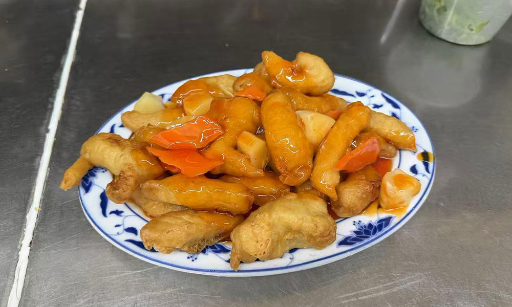 Sweet and sour fried chicken with pineapple, carrots, and glossy orange sauce at Imperial Garden, a Chinese Restaurant in Philadelphia