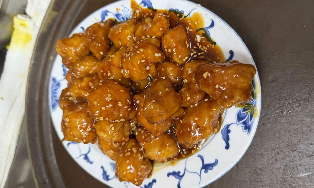 Sesame chicken coated in sweet brown sauce with toasted sesame seeds at Imperial Garden, a Chinese Restaurant in Philadelphia