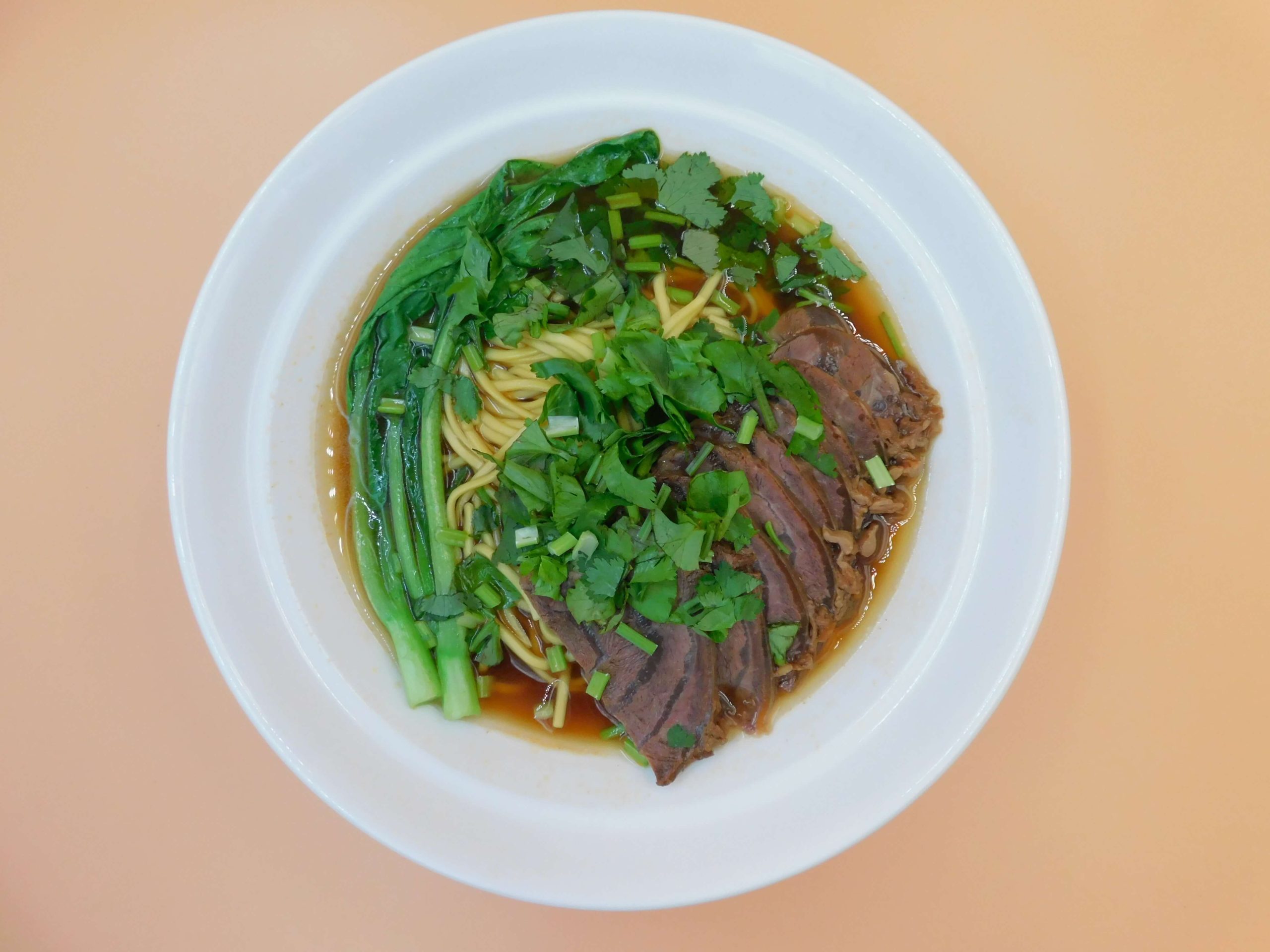 Beef slice noodle soup with fresh cilantro and greens at Okinii Japanese Restaurant & Impressive Noodle, a Asian Fusion Restaurant in Massapequa