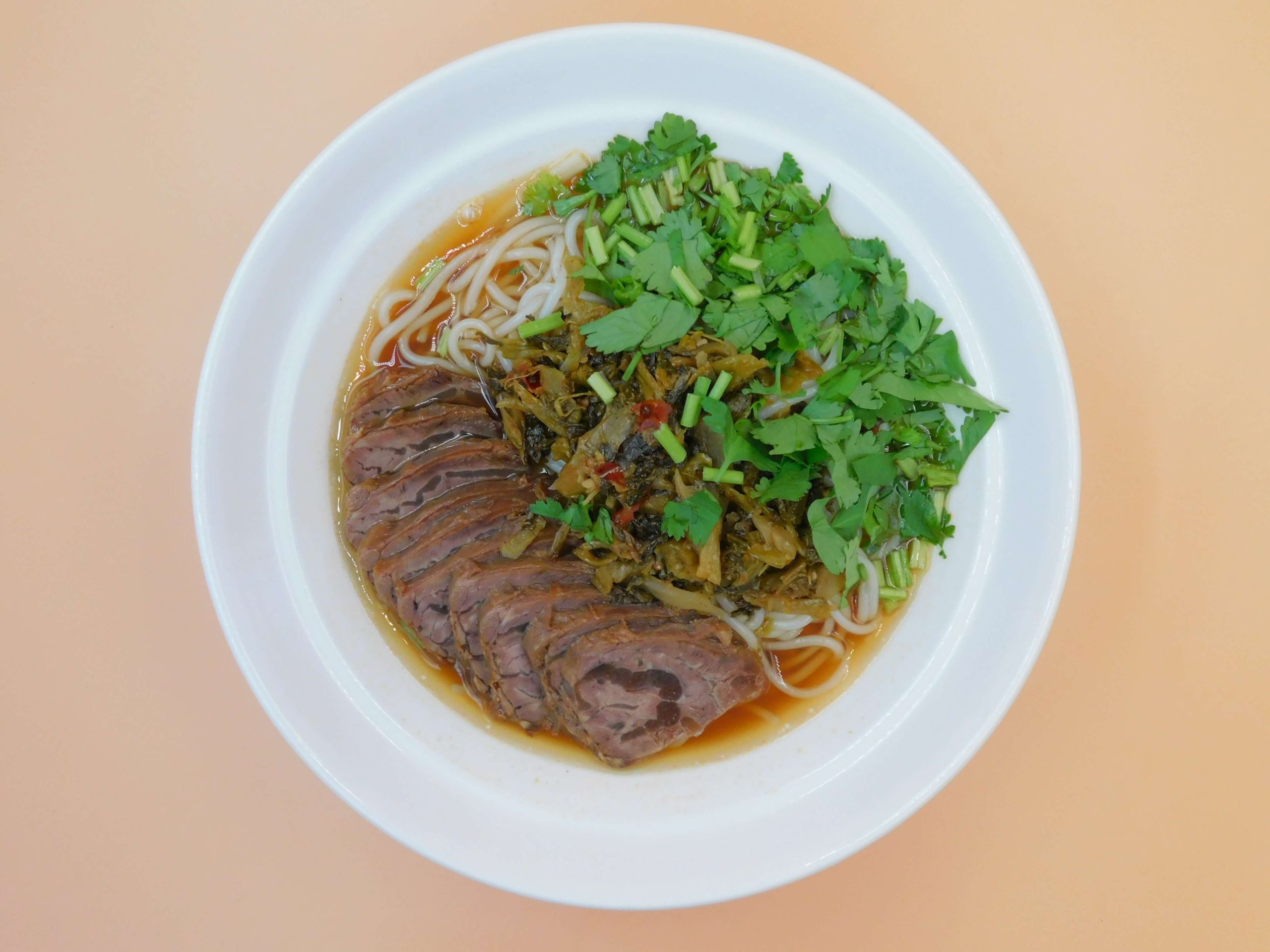 Rice noodle soup with beef slices, pickled veggies and cilantro at Okinii Japanese Restaurant & Impressive Noodle, a Asian Fusion Restaurant in Massapequa