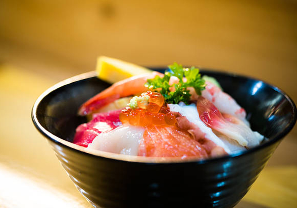 Chirashi don rice bowl topped with mixed sashimi & roe at Inaka, an Asian Fusion Restaurant in Brooklyn