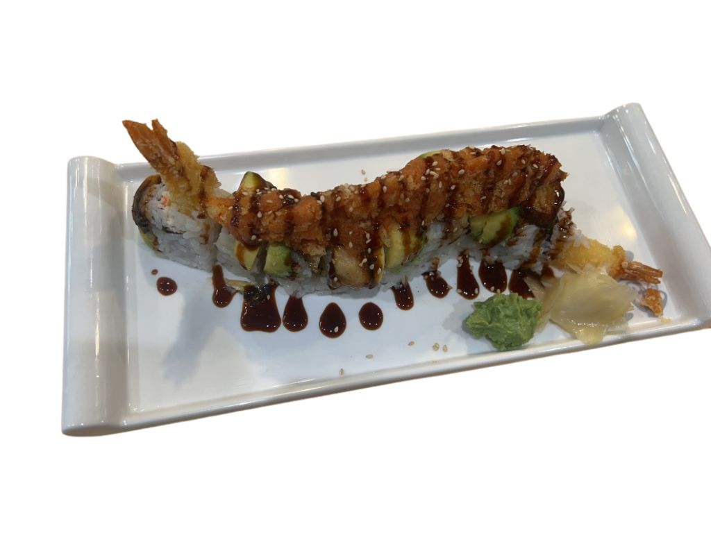 Sushi roll with deep - fried shrimp, avocado, and drizzled sauce at Ippin Ramen & Sushi Bar, a Japanese Restaurant in Mankato
