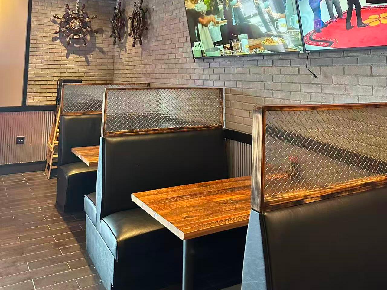 Comfortable booths with wooden tables and decorative ship wheels at Ippin Ramen & Sushi Bar, a Japanese Restaurant in Mankato