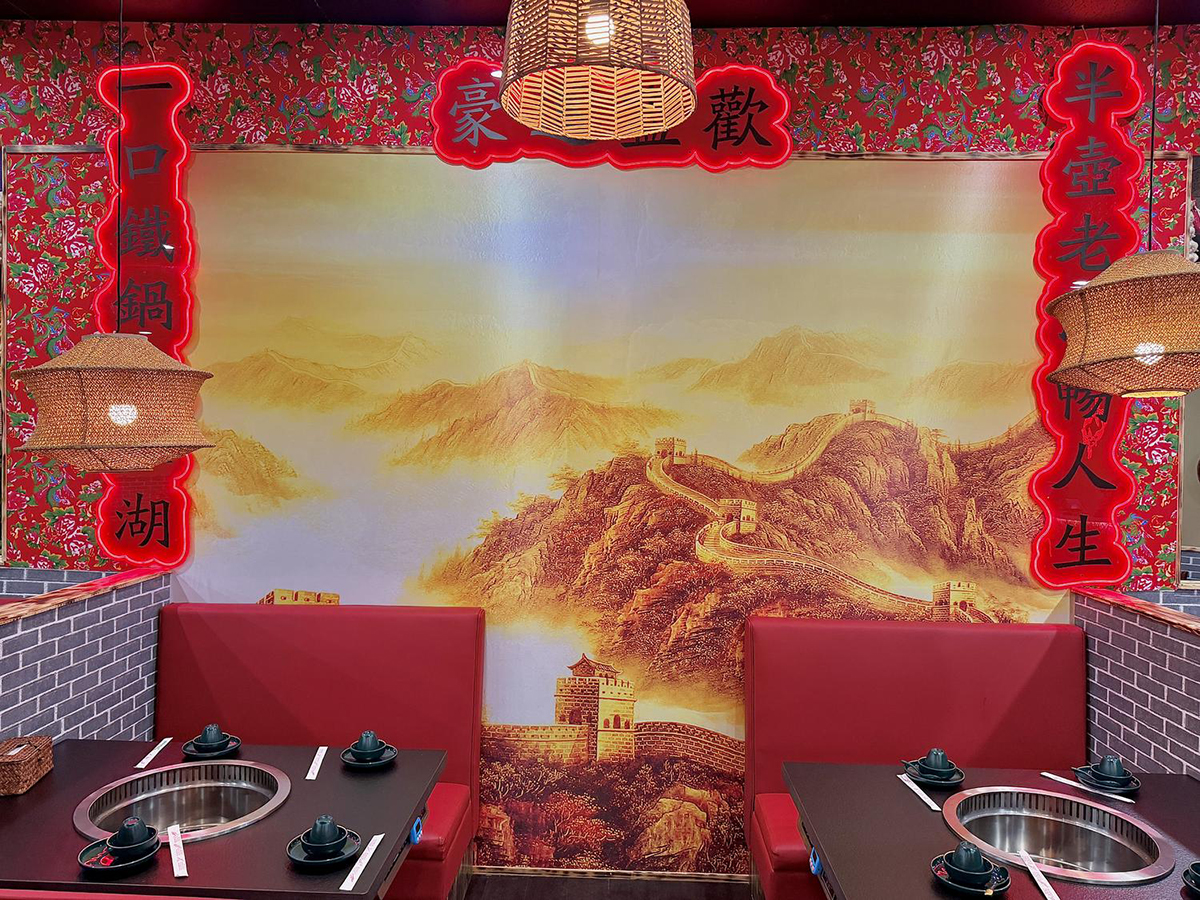 Red lanterns and Chinese landscape wall art at Iron Pot Stew Kitchen, a Chinese Restaurant in Santa Clara