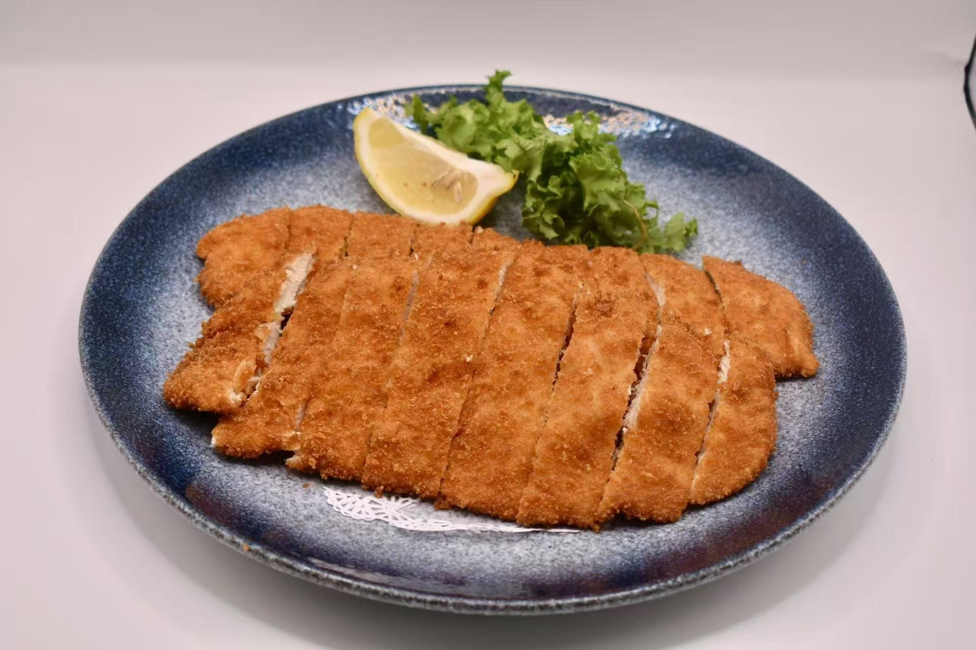 Crispy fried chicken cutlet with lemon at Isohama,a Japanese Restaurant in New York.