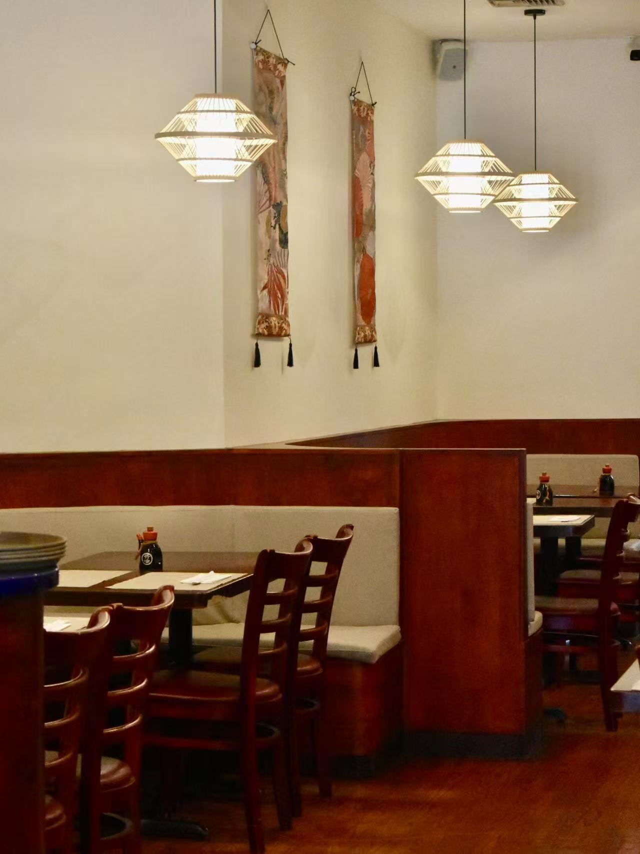 Dining room with tables,chairs and decor at Isohama,a Japanese Restaurant in New York.