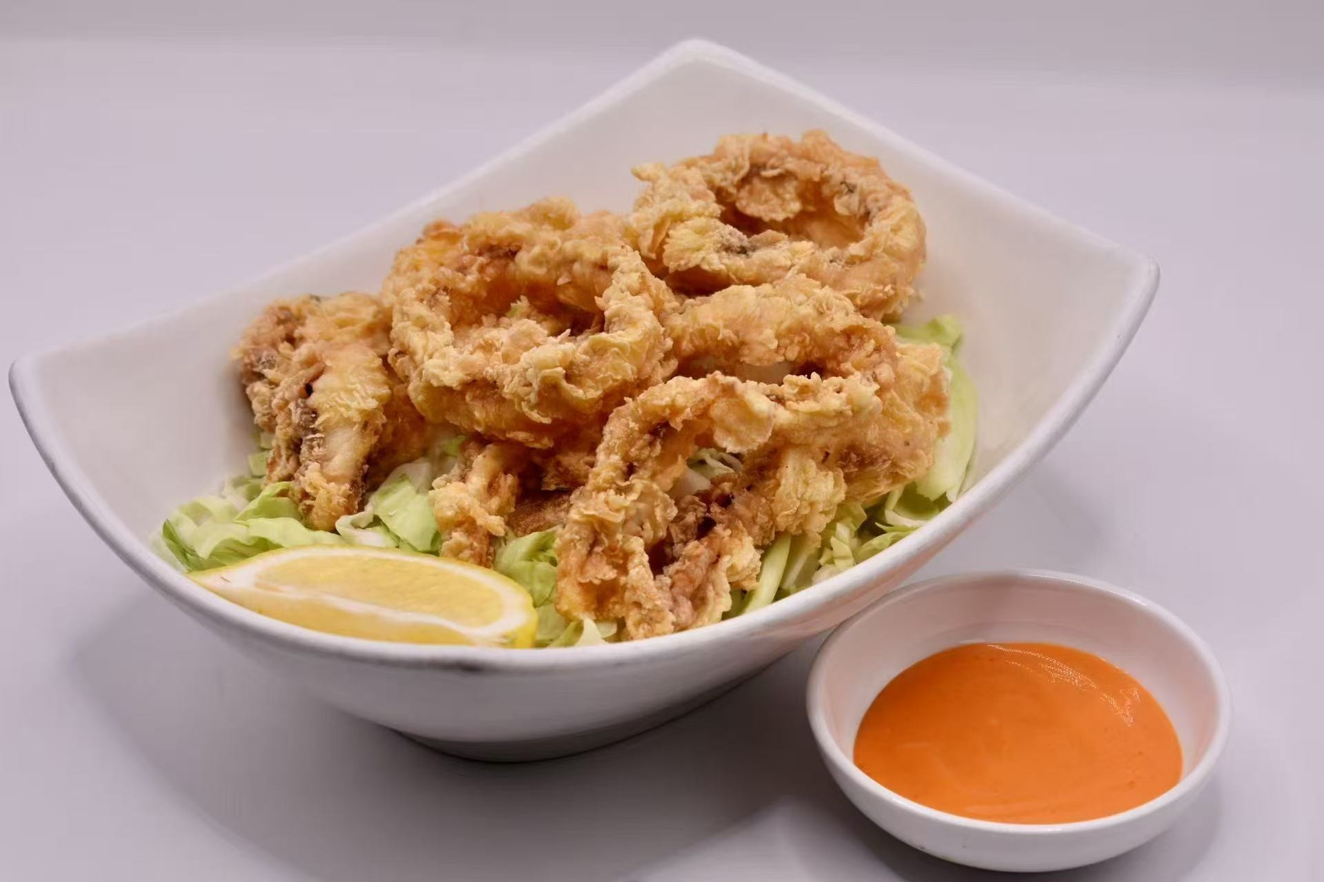 Crispy fried calamari with sauce at Isohama,a Japanese Restaurant in New York.