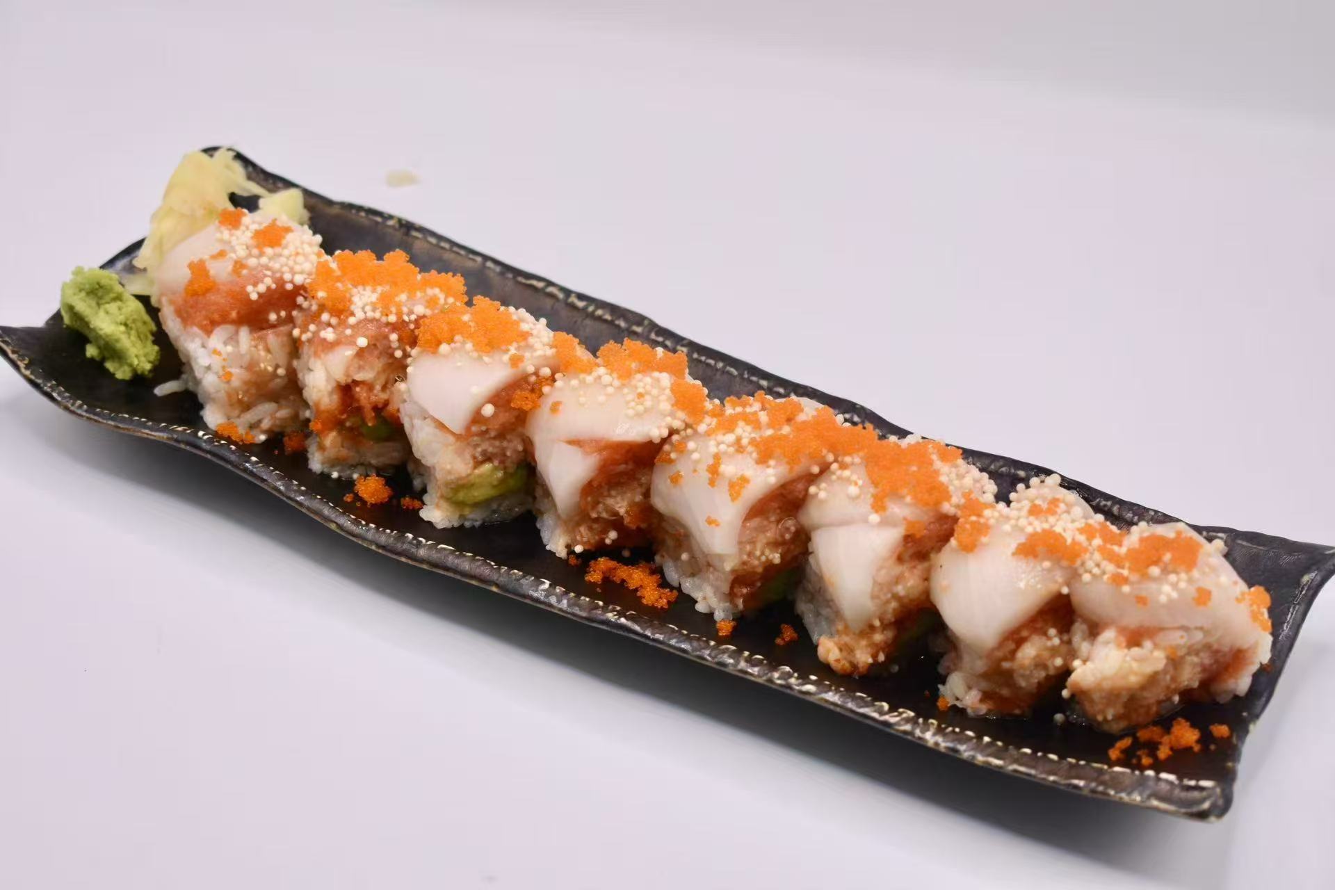 Sushi roll with toppings and sauces at Isohama,a Japanese Restaurant in New York.