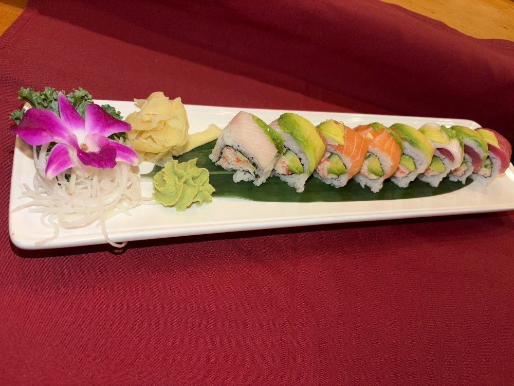 Rainbow sushi roll with assorted fresh sashimi and avocado on top