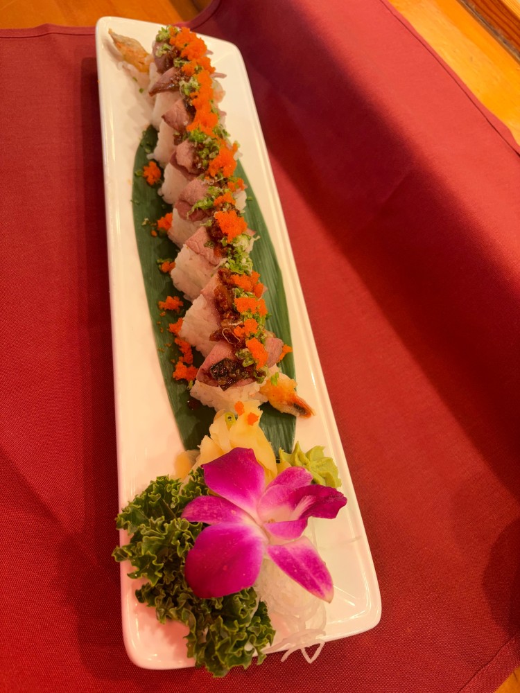 Sushi roll with seared beef, tobiko, green onion and tempura shrimp