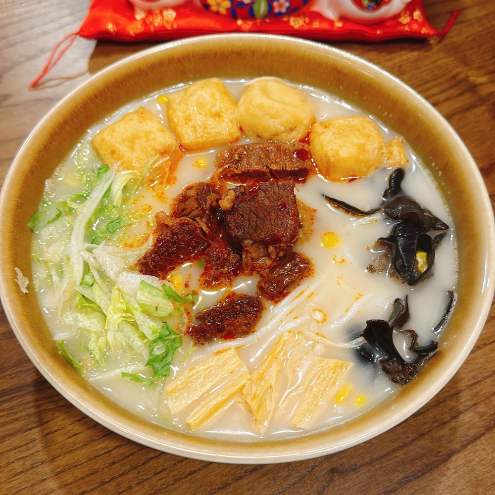 Milky beef rice noodles soup with beef chunks, tofu puffs, black fungus, lettuce and yuba at JBC Rice Noodles Ramen & Dumplings, a Asian Restaurant in Astoria