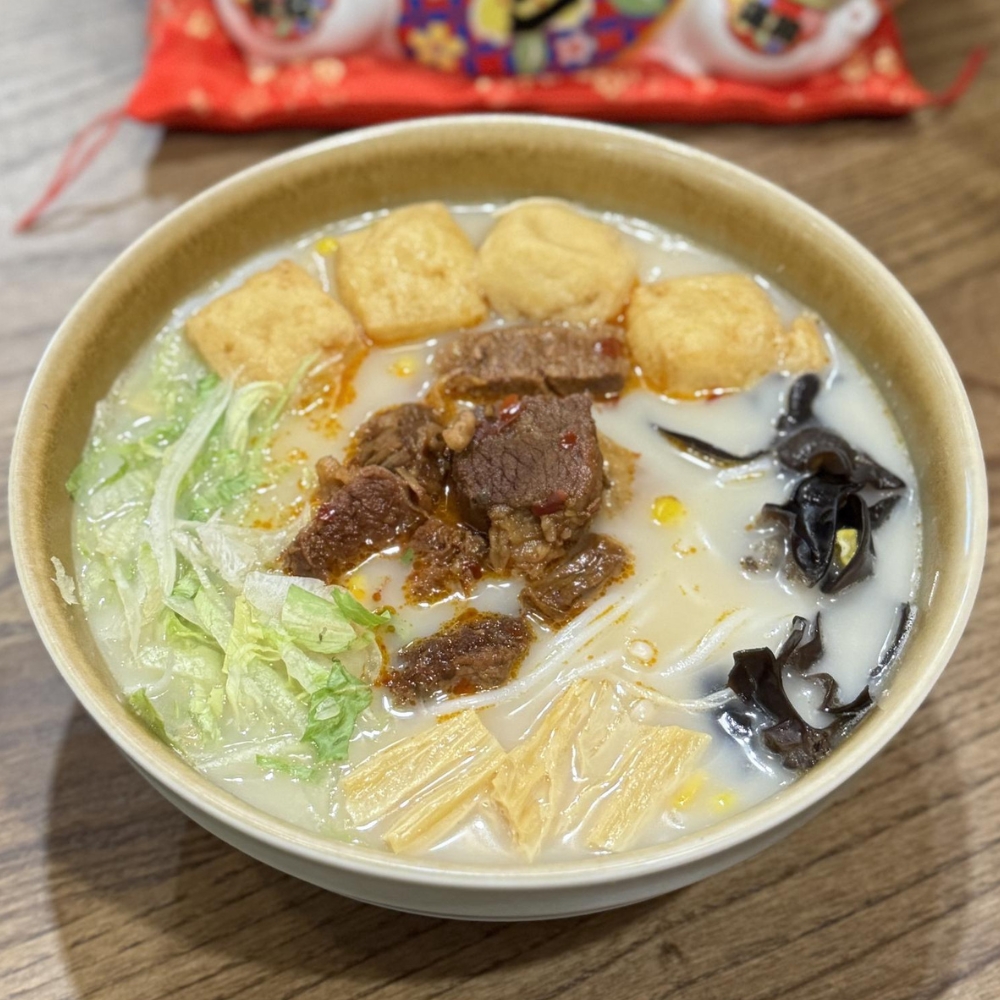 Milky beef rice noodles soup with beef chunks, tofu puffs, black fungus, lettuce and yuba at JBC Rice Noodles Ramen & Dumplings, a Asian Restaurant in Astoria