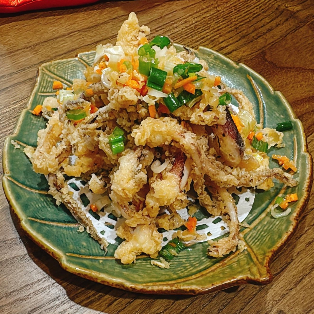 Crispy fried squid topped with green onions and diced carrots at JBC Rice Noodles Ramen & Dumplings, a Asian Restaurant in Astoria