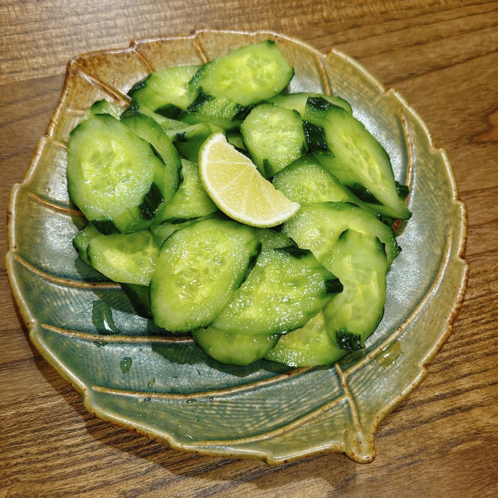Cucumber salad with a slice of lemon at JBC Rice Noodles Ramen & Dumplings, a Asian Restaurant in Astoria