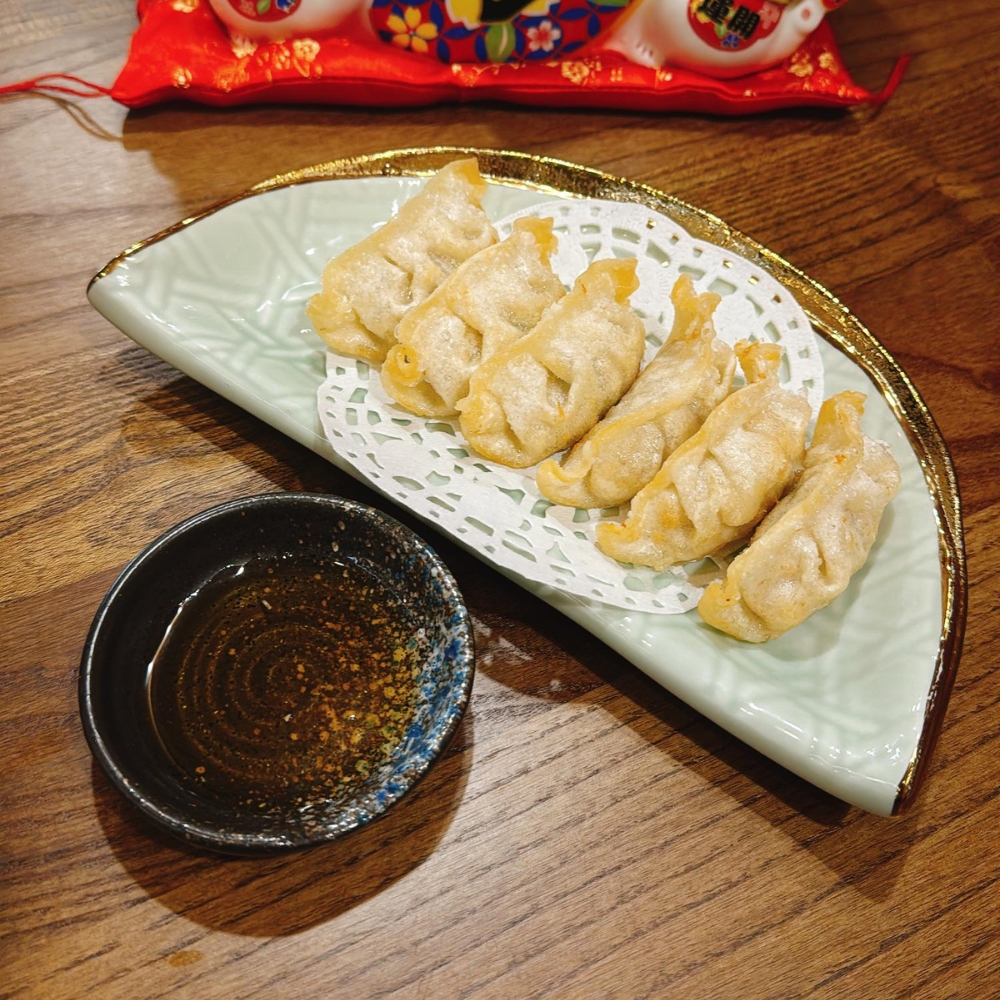Fried dumplings served with dipping sauce at JBC Rice Noodles Ramen & Dumplings, a Asian Restaurant in Astoria