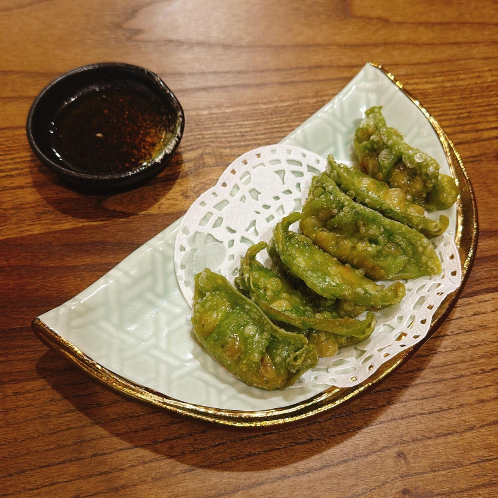 Fried snow pea dumplings served with dipping sauce at JBC Rice Noodles Ramen & Dumplings, a Asian Restaurant in Astoria