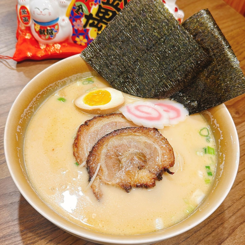 Creamy pork ramen with chashu, egg, nori, green onions and fish cake at JBC Rice Noodles Ramen & Dumplings, a Asian Restaurant in Astoria
