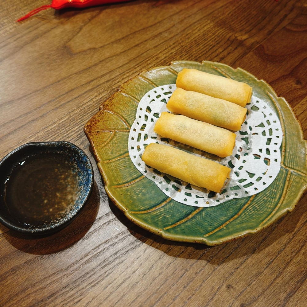 Crispy vegetable spring rolls served with dipping sauce at JBC Rice Noodles Ramen & Dumplings, a Asian Restaurant in Astoria
