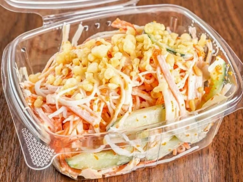 Jin-Poke-Asian-Restaurant-Spicy-Kani-Salad-Seminole A container with spicy kani, cucumber, and toppings at Jin Poke, a Asian Restaurant in Seminole