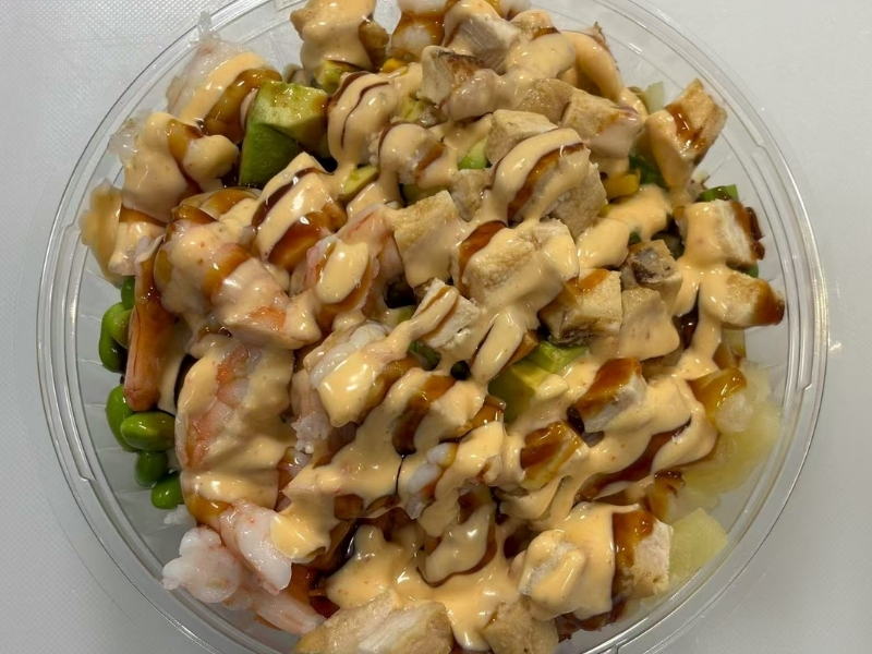 Jin-Poke-Asian-Restaurant-The-Wave-Seminole A bowl with shrimp, chicken, and sauces at Jin Poke, a Asian Restaurant in Seminole