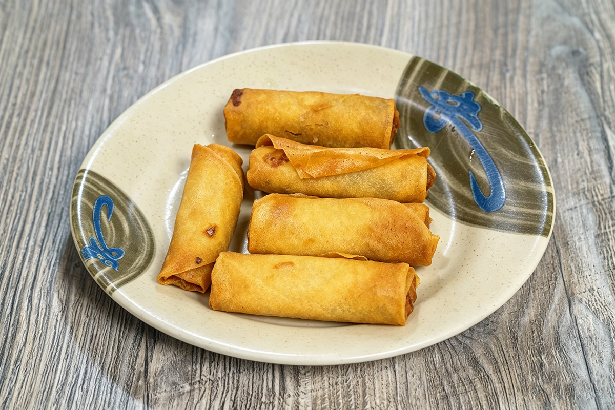 Crispy fried spring rolls on a ceramic plate at J&L Chinese Cafe, a Chinese Restaurant in Pasadena