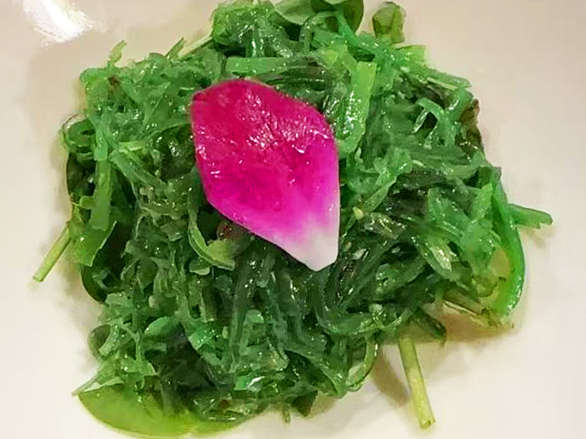 Refreshing seaweed salad (wakame) with a pickled radish garnish at Joe's Yummy Bowl，a Asian Restaurant in Flint