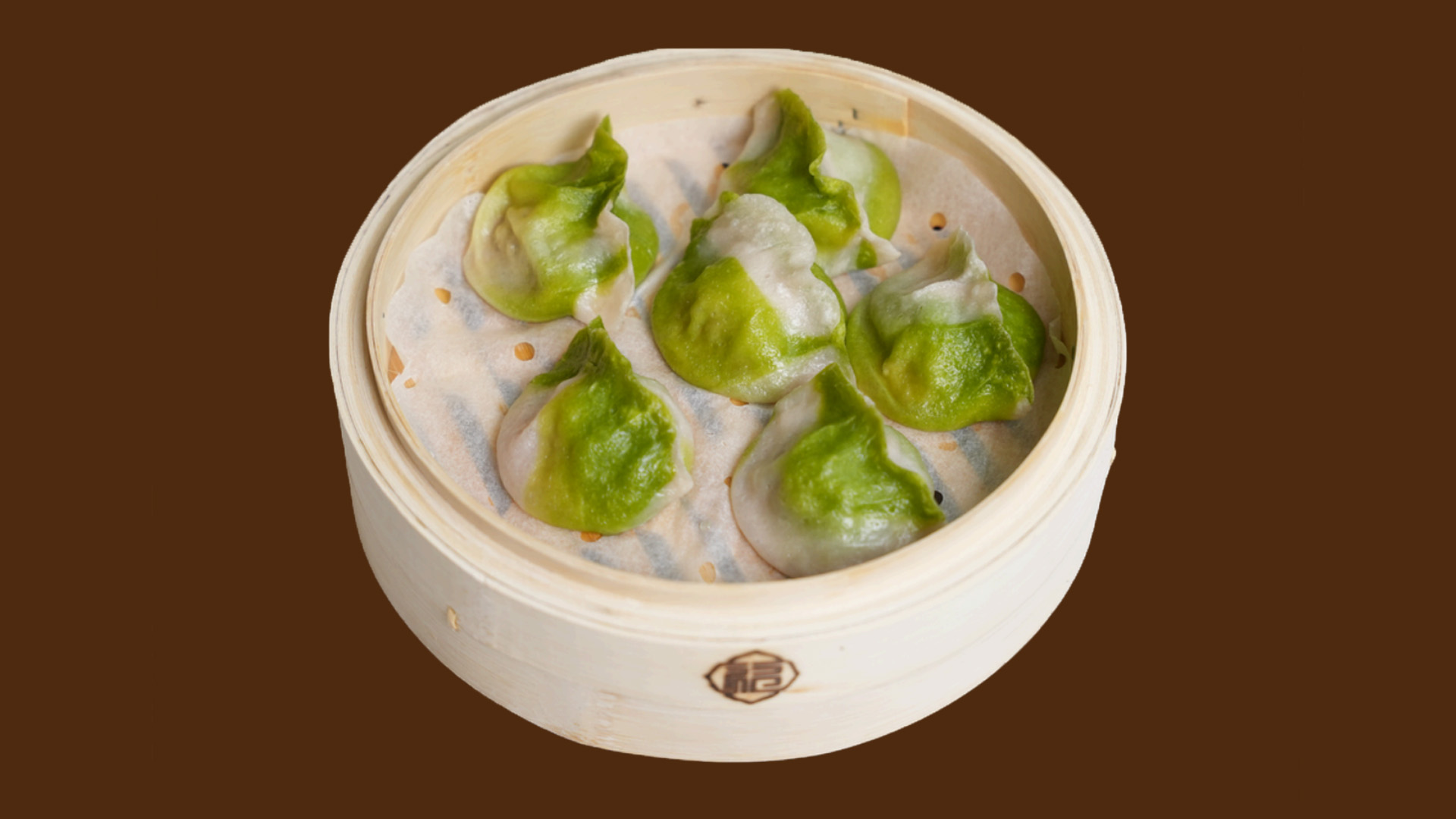 Jade green half-transparent crystal dumplings in bamboo steamer at JoyFu Dim Sum, a Dim Sum Restaurant in New York