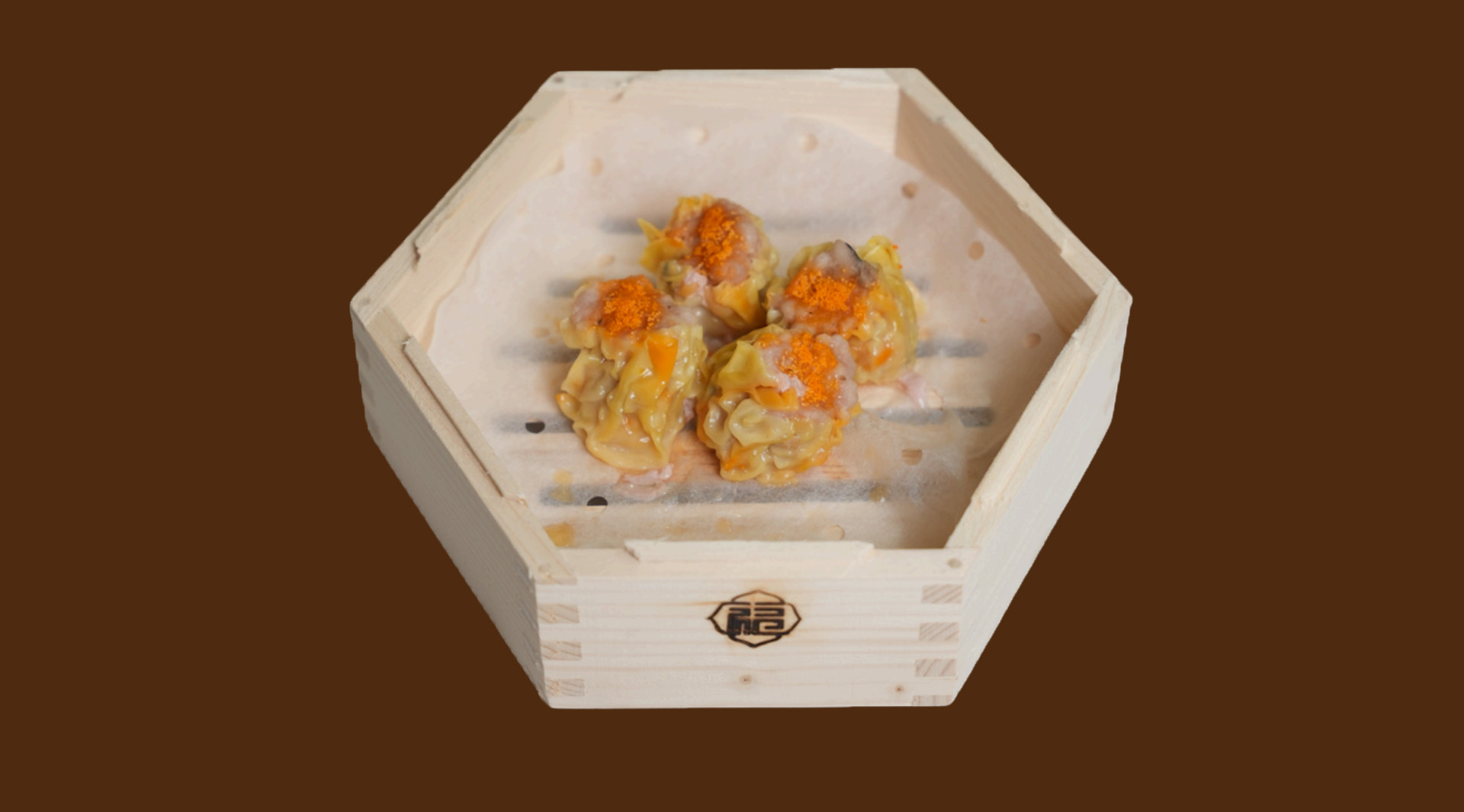 Siu mai topped with fish roe in hexagonal wooden tray at JoyFu Dim Sum, a Dim Sum Restaurant in New York