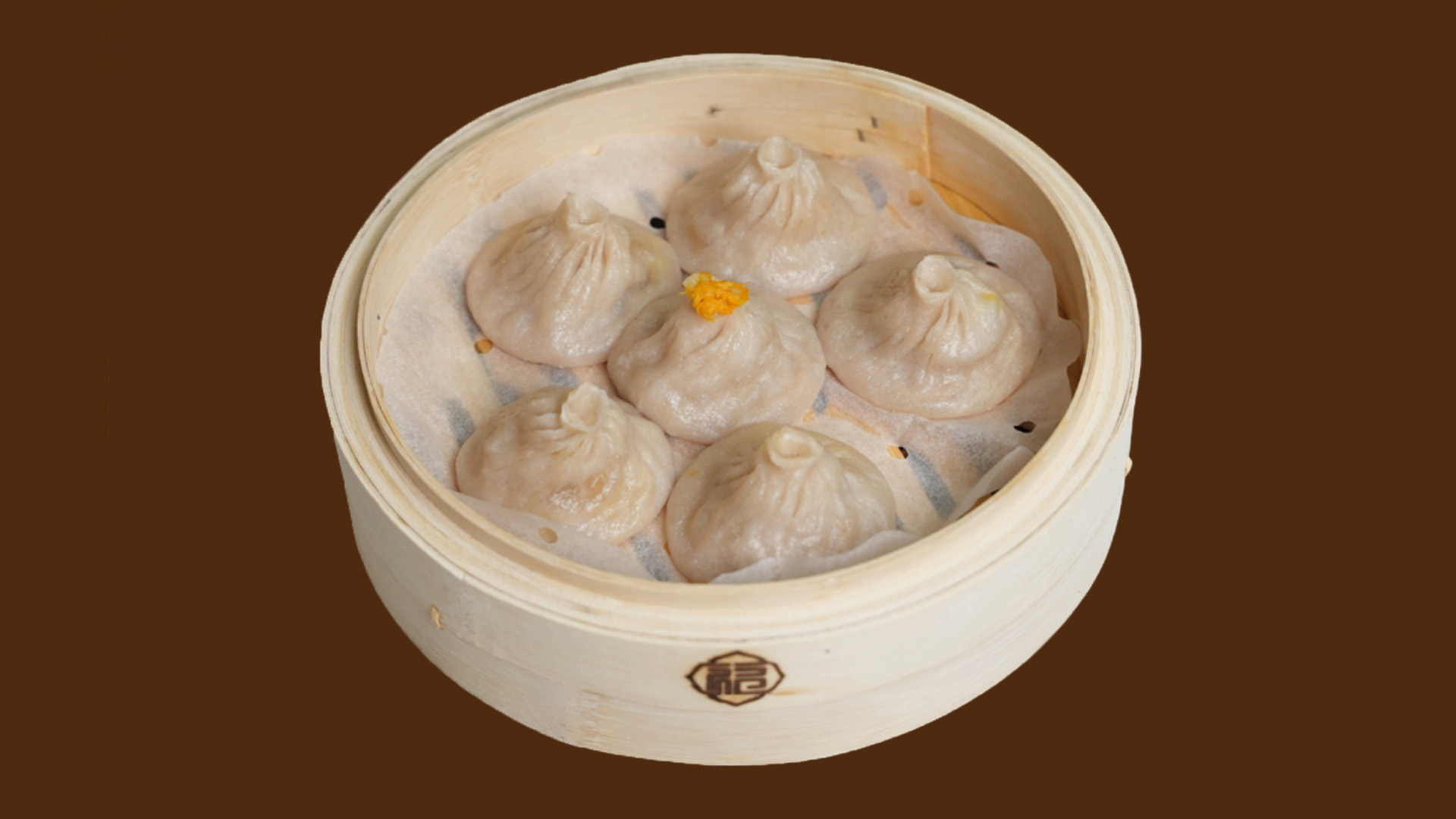 Six classic crab roe soup dumplings in bamboo steamer at JoyFu Dim Sum, a Dim Sum Restaurant in New York