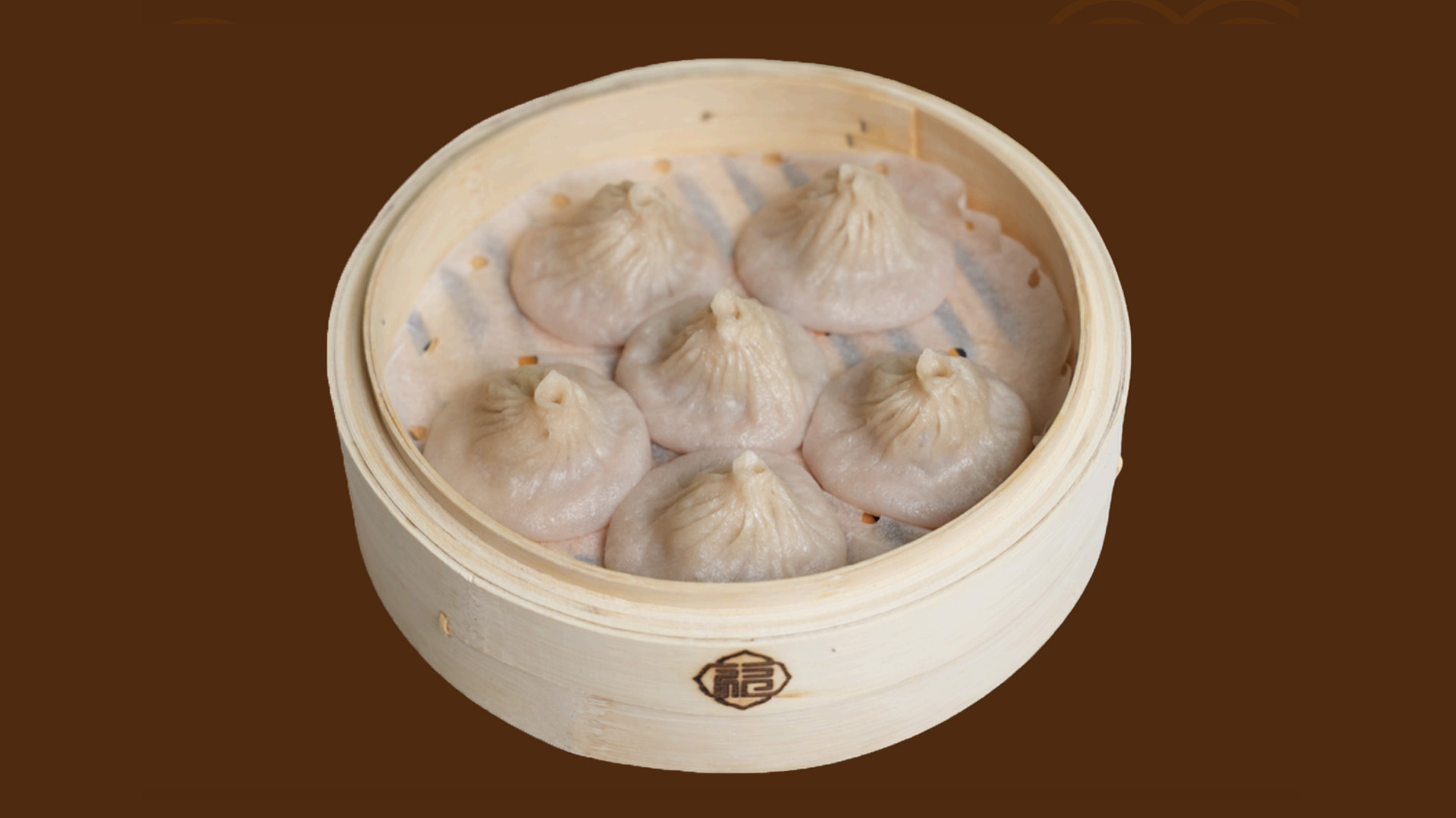 Six plain pork soup dumplings in bamboo steamer at JoyFu Dim Sum, a Dim Sum Restaurant in New York
