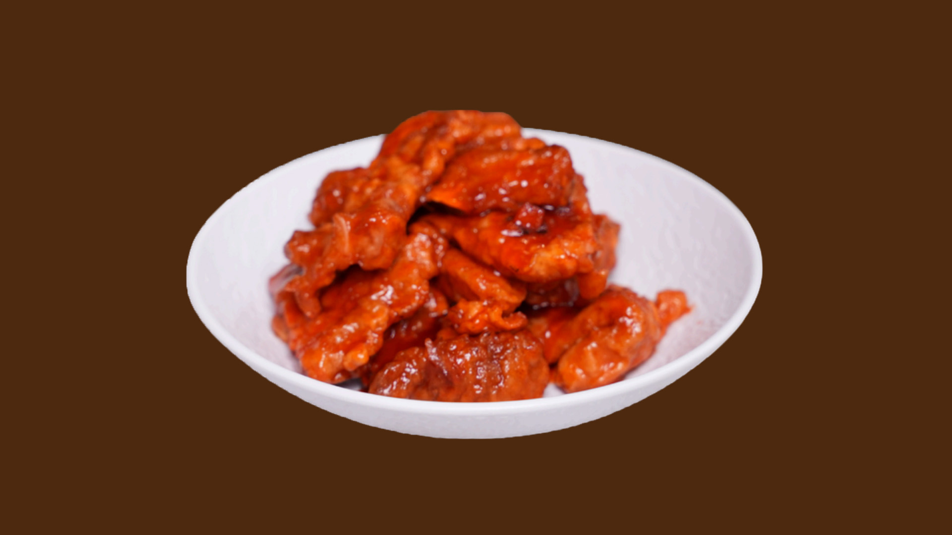 Sweet sour crispy pork slices on white plate at JoyFu Dim Sum, a Dim Sum Restaurant in New York