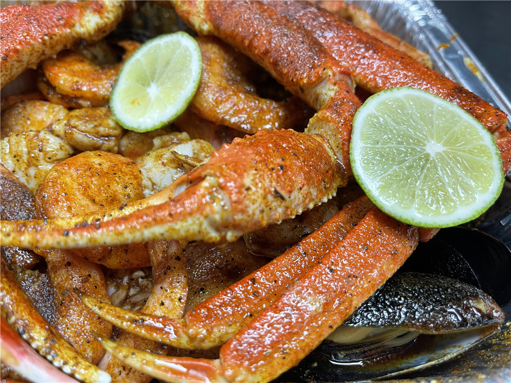 Fresh king crab legs on rustic wooden table at The Juicy Seafood-Pearl, a Seafood in Pearl