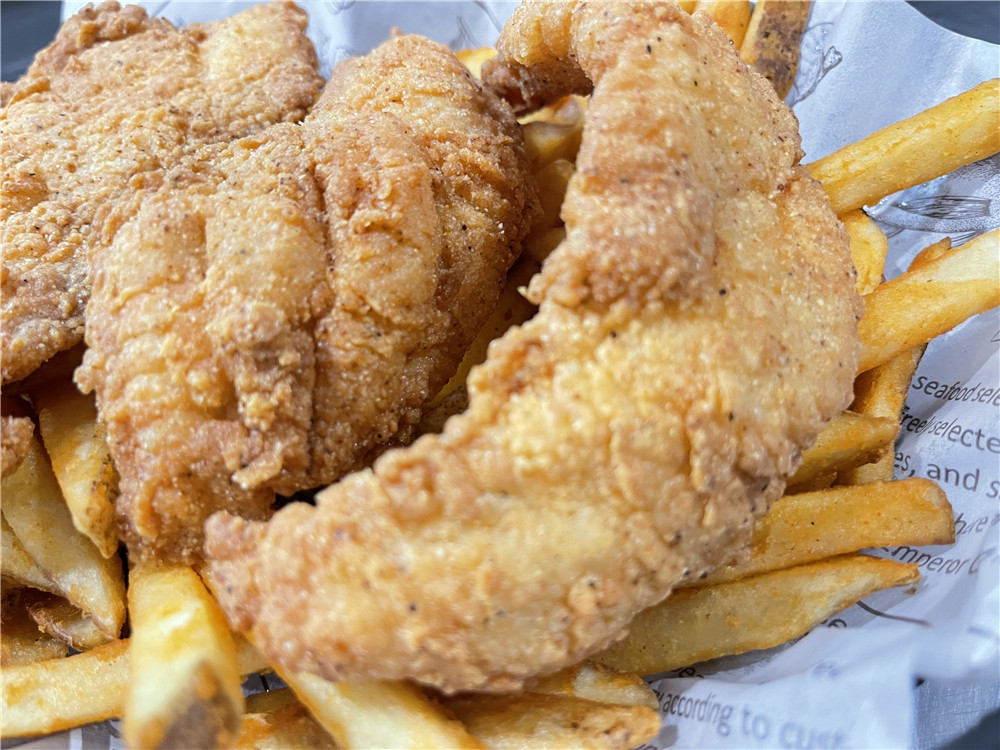 Crispy fried fish fillets with golden fries at The Juicy Seafood-Pearl, a Seafood in Pearl