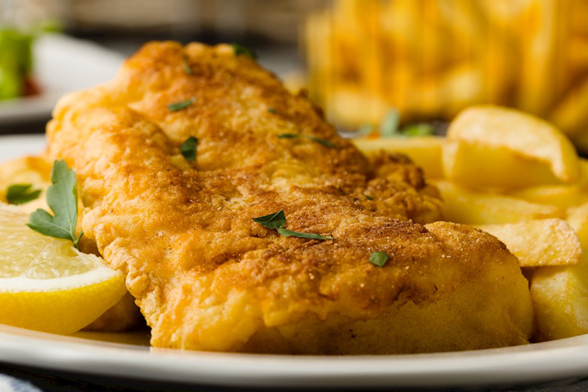 Fried cod with french fries on white plaet at Jumper Seafood，a Seafood Restaurant in Tampa