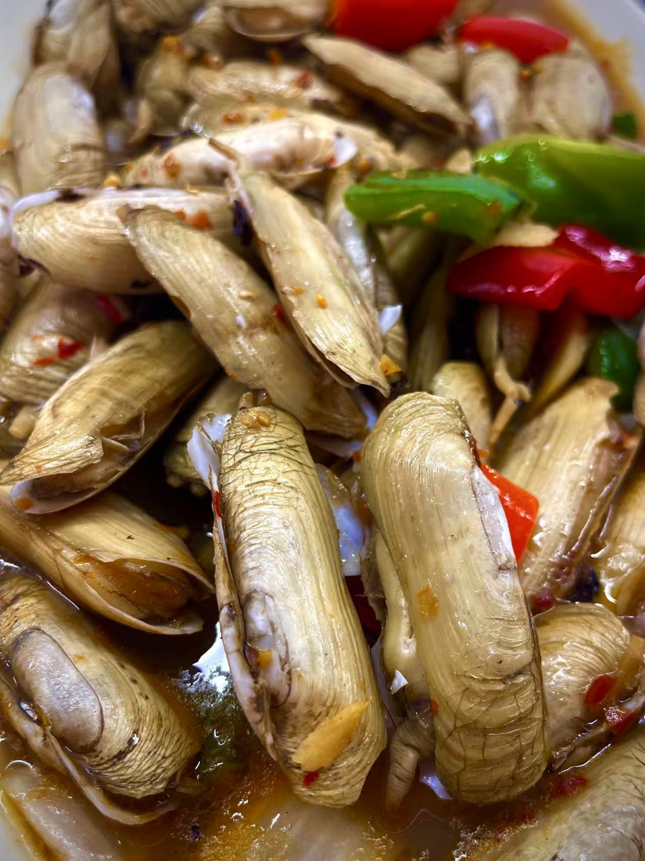 Clam Dish - Clams stir - fried with peppers, offering a spicy and savory flavor at JW Asian Seafood Buffet, a Buffet restaurant in Long Island City