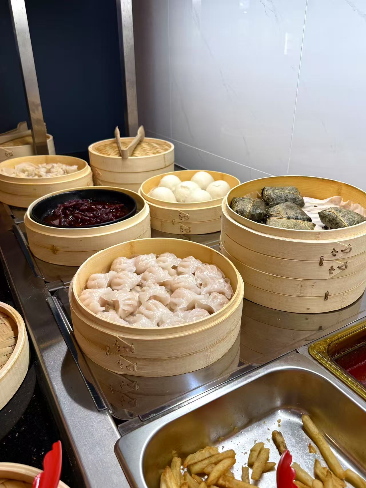 Dim Sum - A variety of dim sum like shrimp dumplings and steamed buns in bamboo steamers at JW Asian Seafood Buffet, a Buffet restaurant in Long Island City