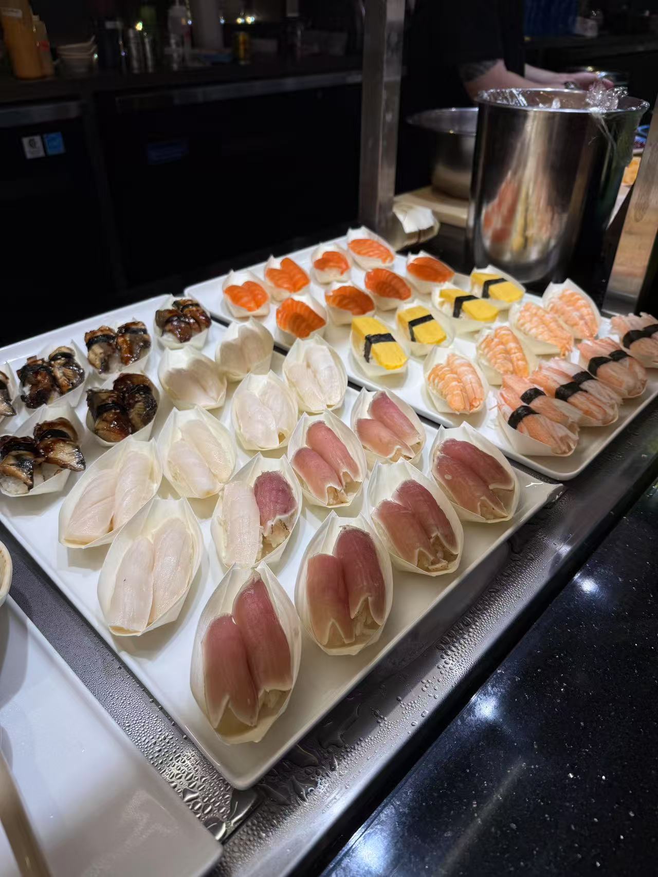 Sushi and Sashimi Array - A variety of sushi and sashimi neatly displayed at JW Asian Seafood Buffet, a Buffet restaurant in Long Island City
