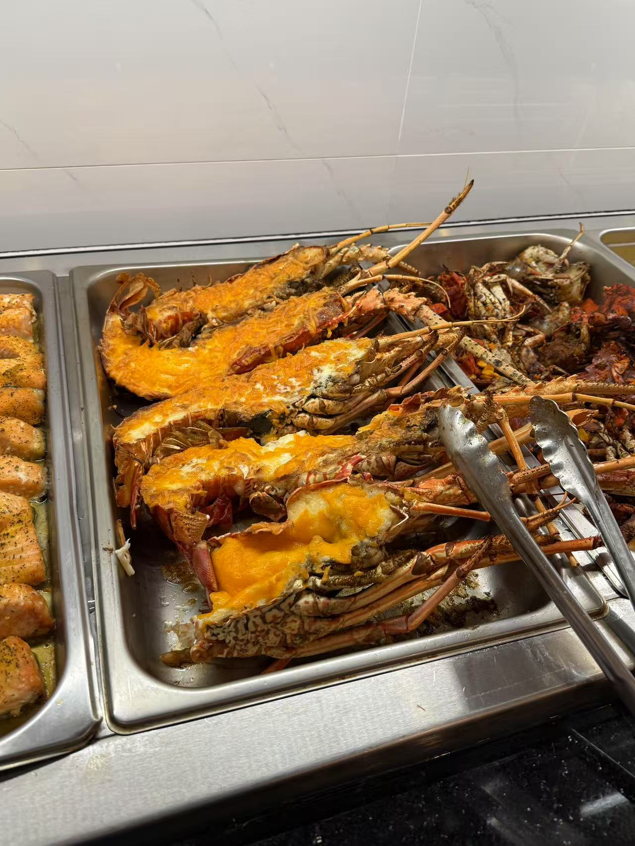 Baked Lobster with Cheese - Lobsters baked golden, topped with melted cheese at JW Asian Seafood Buffet, a Buffet restaurant in Long Island City